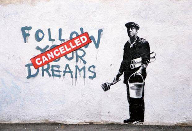 Banksy mural which says 'follow your dreams' with a canceled banner covering which is a comment of cutting arts from society.